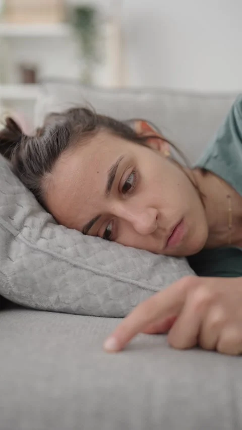 Woman with depression lying on sofa Stock-Footage 240096031