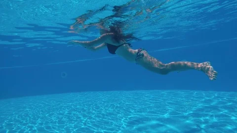 Woman descends the ladder to the pool Stock Footage