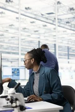 Woman designing complex PCB layout on computer monitor 写真素材
