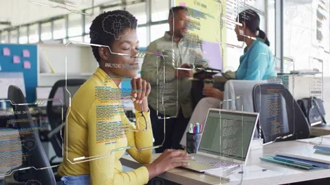 Woman at desk coding on laptop, holding specs, UI overlays filling scene causing 스톡 동영상 333004734