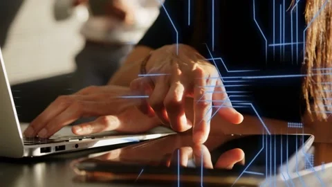 Woman dev tapping tablet, code overlays appearing over hands while typing on Stockbeeldmateriaal 335282036