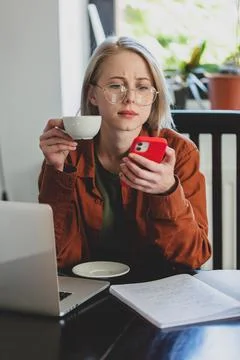 Woman developer with computer and mobile phone at home office Foto stock