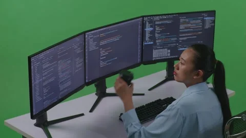 Woman Developer Drinking Coffee And Using Computer To Write Code With Multiple Stock Footage 252578221