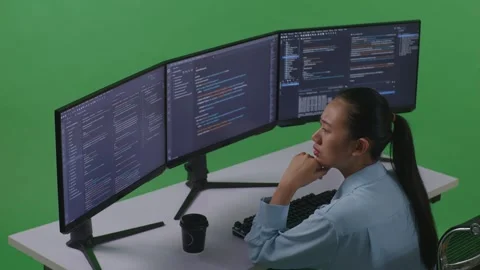 Woman Developer Thinking About Something While Write Code With Multiple Computer Stock Footage 252578283
