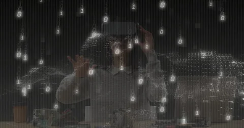 Woman developer wearing VR headset interacting at tech desk with cables and Video stock 307448316