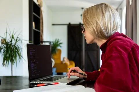 Woman developer working with computer at home office Stock Photos