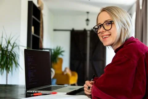 Woman developer working with computer at home office Stock Photos