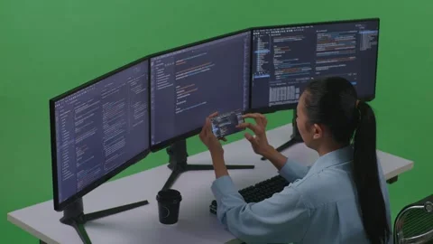 Woman Developer Working With Mobile Phone While Write Code With Multiple Video stock 252577968