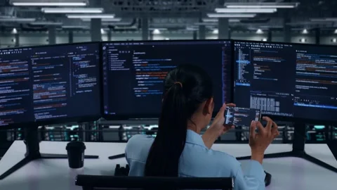 Woman Developer Working With Mobile Phone While Write Code In Data Center Stock Footage 270230165