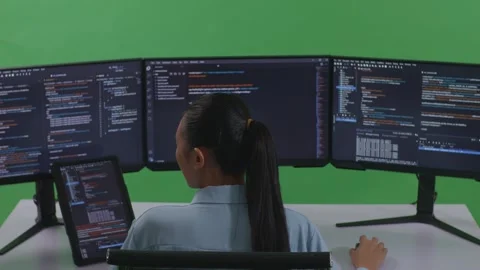 Woman Developer Working With Tablet While Write Code With Multiple Computer Stock Footage 252571538