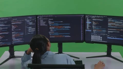 Woman Developer Write Code With Multiple Computer Screens In Green Screen Studio Stock Footage 252572427