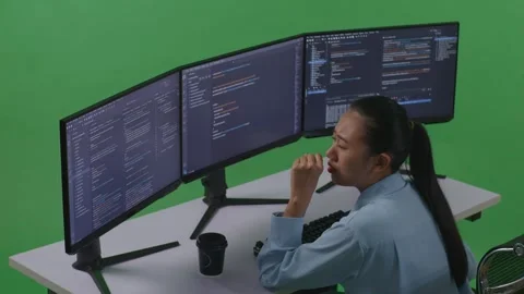 Woman Developer Yawning While Write Code With Multiple Computer Screens Stock Footage 252578628