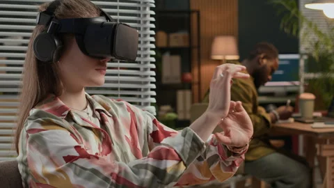 Woman Developing in VR Glasses while Male Colleague Coding in Background Stock Footage 302893951