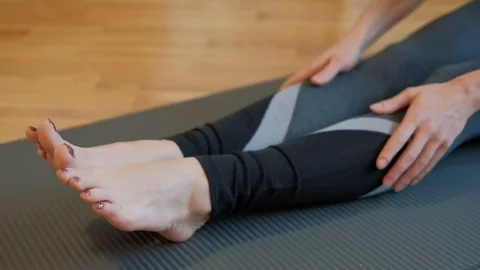 The woman develops flexibility by leaning the body forward Stock Footage 74727575