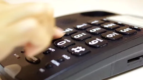A woman dialling a number on a push button phone Stock Footage 43361194
