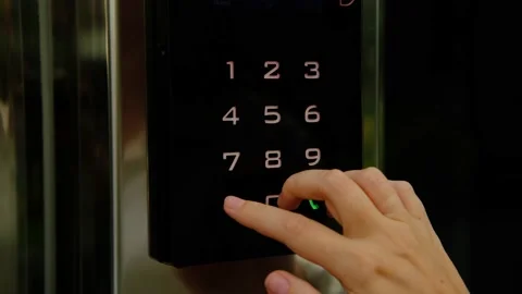 A woman dials a code on the intercom panel. Stock Footage 228678227