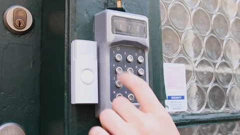 Woman dials a code of intercome and opens a door of a house Stock Footage 116658106