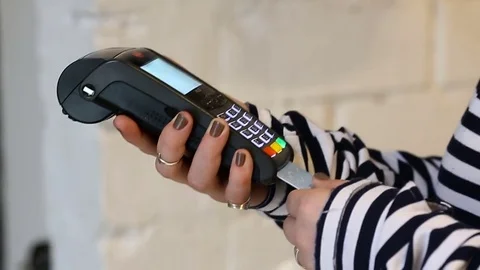 Woman dials PIN code to purchase in store Stock Footage 72802591