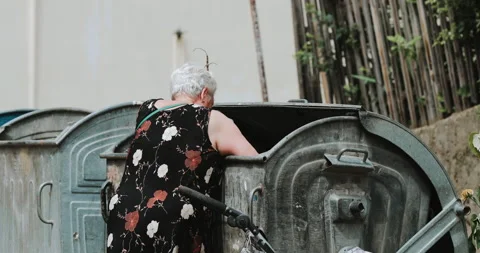 Woman digging in the trash Stock Footage 134581377
