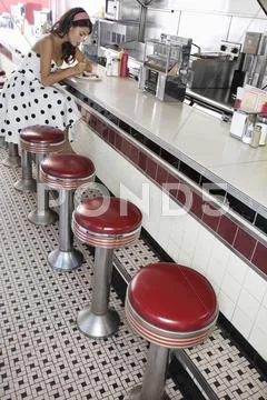 Woman At Diner Counter Stock Photos