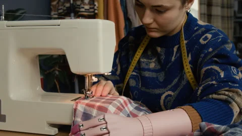 Woman with Disability Fixing Shirt, Using Sewing Machine Stock Footage 328359094