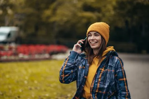 Woman with disability using a smartphone while out in the city park Stock Photos