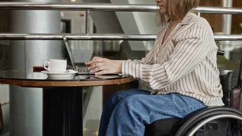Woman with Disability Working on Laptop Computer in Cafe Stock Footage 343792958