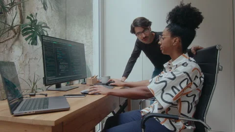 Woman Discussing Program Code with Male Colleague 스톡 동영상 252759526