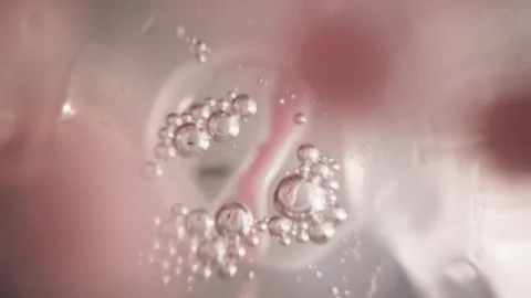 Woman dissolves raspberry balls for sweet berry taste Stock Footage 243788559