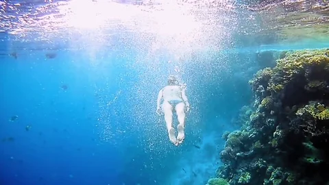 Woman dive underwater in snorkeling diving mask Stock Footage