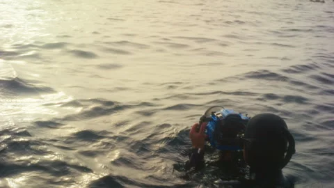A woman Diver checking her camera Stock Footage 279423197
