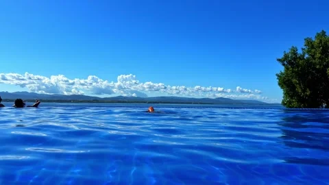 Woman diving into the infinity pool at Dusit Thani Cebu Philippines Vídeos de archivo 334579026
