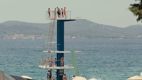 Woman Diving From Public Diving Platform Into Adriatic Sea Stock Footage 340511946