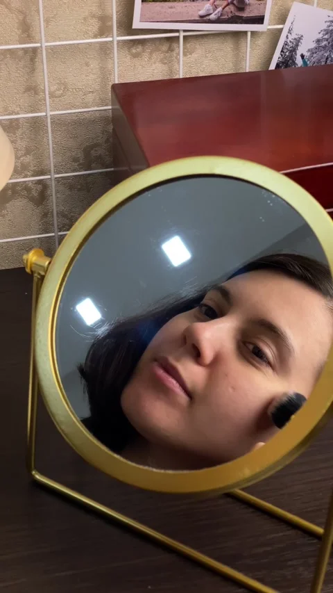 Woman do make up in front of mirror Stock Footage 252735877