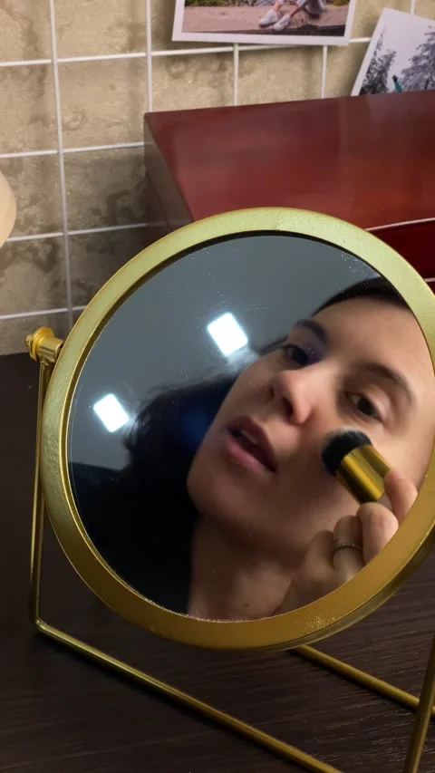 Woman do make up in front of mirror Stock Footage 252881410