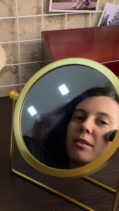 Woman do make up in front of mirror Stock Footage 252881454