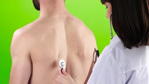 Woman doctor is listening lungs man stethoscope. Green screen Stock Footage