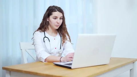 Woman doctor talking to client using virtual chat computer app. Female medical  Stock Footage 145239639