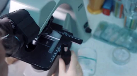 Woman doctor using her microscope in a laboratory Stock Footage 66728535