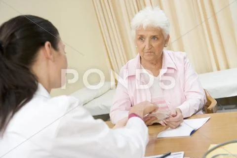 Woman in doctor's office frowning Stock Photos