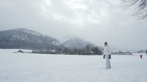 Woman does cartwheel in snow in Mountains of Bavaria Slow motion Stock Footage 121754360