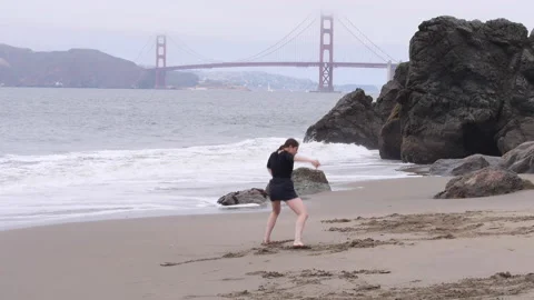 Woman Does Dramatic and Emotional Interpretive Dance on the Beach, Golden Stock Footage 157135997