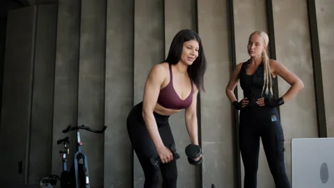 Woman does exercise with weight under control of coach Stock Footage 211080509