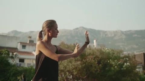 A woman does exercises from the eastern practice of qigong Stock Footage 257670409