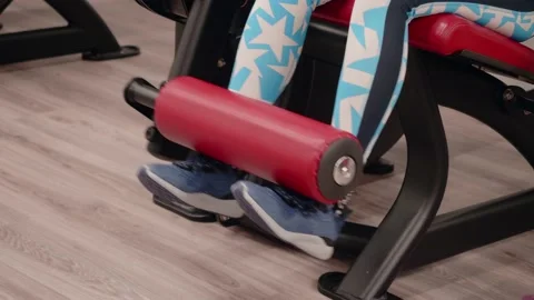 Woman does leg extension exercise in machine. Stock Footage 170191758