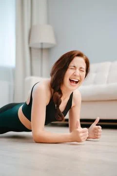 Woman does sports at home and does exercises. Stock Photos