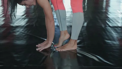 A woman does a warm-up before training. Start a fitness routine. Stock Footage 166691467