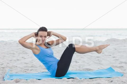 Woman doing abdominal crunches on exercise mat Stock Photos