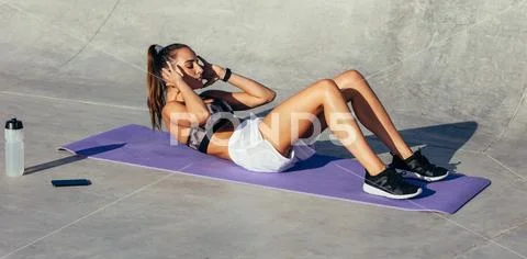 Woman doing abs workout Stock Photos