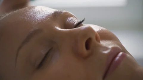 Woman doing anti-aging massage for skin care in a luxury spa salon. Cosmetology  Stock Footage 120577553
